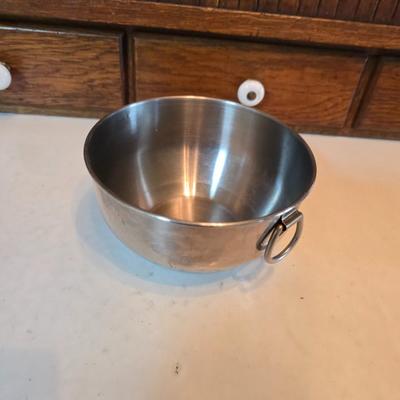 Stainless steel bowls and a strainer with an apron