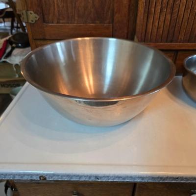 Stainless steel bowls and a strainer with an apron