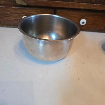 Stainless steel bowls and a strainer with an apron