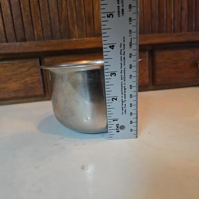 Stainless steel bowls and a strainer with an apron