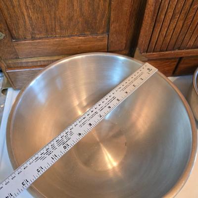 Stainless steel bowls and a strainer with an apron