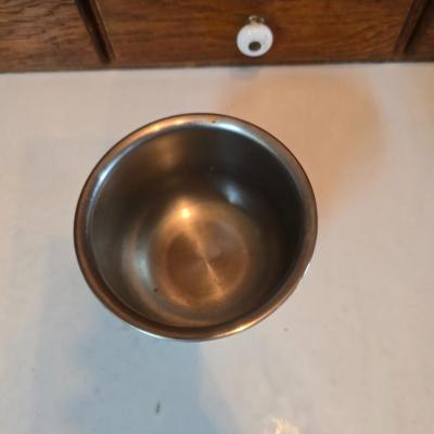 Stainless steel bowls and a strainer with an apron
