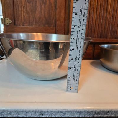Stainless steel bowls and a strainer with an apron