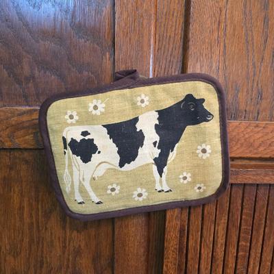 Cow canister - Ceramic cow themed crock - copper-toned cast iron trivet in the shape of a cow - and more