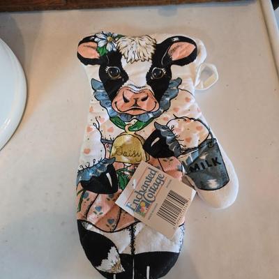 Cow canister - Ceramic cow themed crock - copper-toned cast iron trivet in the shape of a cow - and more