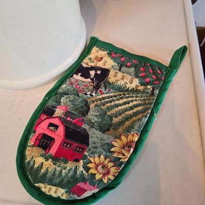 Cow canister - Ceramic cow themed crock - copper-toned cast iron trivet in the shape of a cow - and more