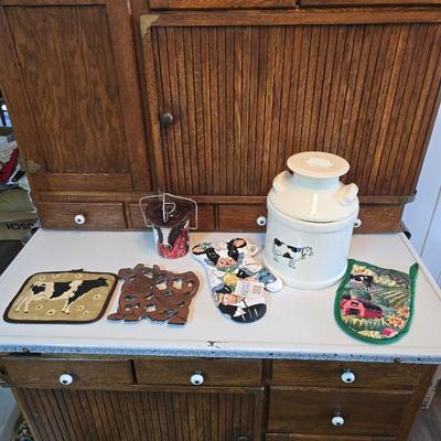 Cow canister - Ceramic cow themed crock - copper-toned cast iron trivet in the shape of a cow - and more