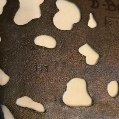 Cow canister - Ceramic cow themed crock - copper-toned cast iron trivet in the shape of a cow - and more