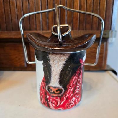 Cow canister - Ceramic cow themed crock - copper-toned cast iron trivet in the shape of a cow - and more
