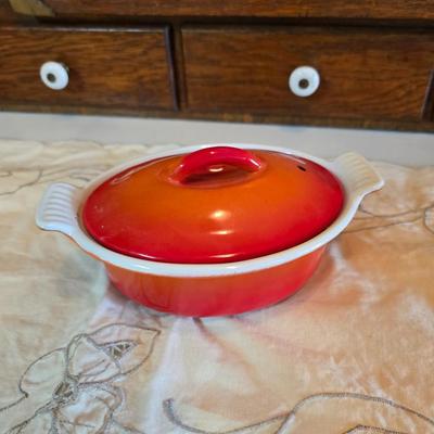 Vintage Le Creuset heritage-style Decoware mini Dutch oven or casserole dish in the signature Flame Orange color.