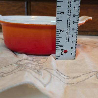 Vintage Le Creuset heritage-style Decoware mini Dutch oven or casserole dish in the signature Flame Orange color.