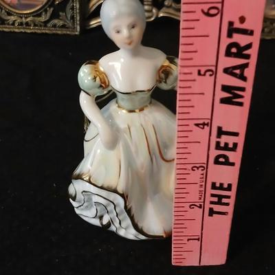 Framed print of the painting "The Hidden Gazebo" by Thomas Kinkade - Two ornate brass picture frames featuring a floral still...