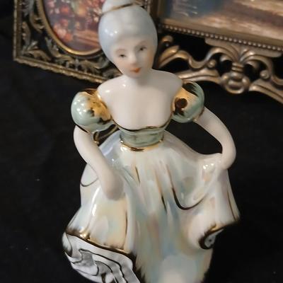 Framed print of the painting "The Hidden Gazebo" by Thomas Kinkade - Two ornate brass picture frames featuring a floral still...