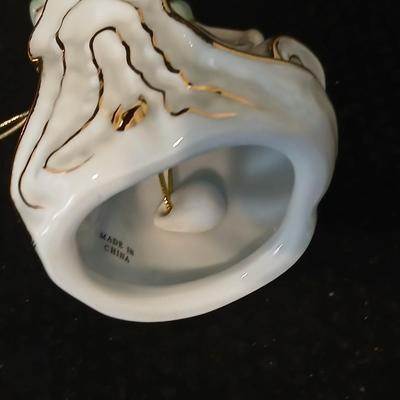 Framed print of the painting "The Hidden Gazebo" by Thomas Kinkade - Two ornate brass picture frames featuring a floral still...