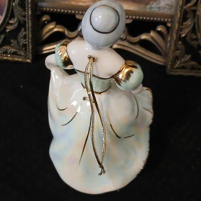 Framed print of the painting "The Hidden Gazebo" by Thomas Kinkade - Two ornate brass picture frames featuring a floral still...