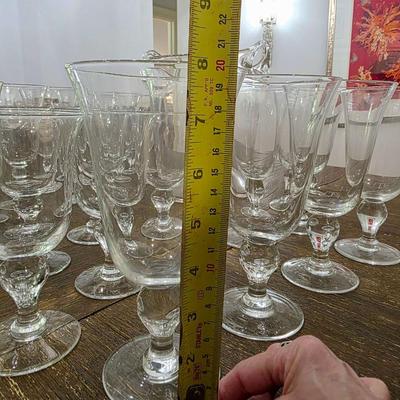 Sale Photo Thumbnail #113: This is a lot including a glass ice bucket and 19 goblets, 2 different sizes. Please see measurements in pictures. The art you may see in the background is NOT included. You are bidding on the lot meaning you must pay for and take the entire lot.