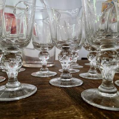 Sale Photo Thumbnail #112: This is a lot including a glass ice bucket and 19 goblets, 2 different sizes. Please see measurements in pictures. The art you may see in the background is NOT included. You are bidding on the lot meaning you must pay for and take the entire lot.