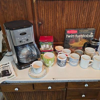 Brand new Cusinart coffee maker with a collection of mugs - including two insulated mugs and a turntable / lazy Susan