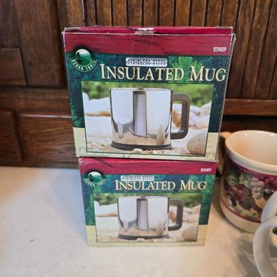 Brand new Cusinart coffee maker with a collection of mugs - including two insulated mugs and a turntable / lazy Susan