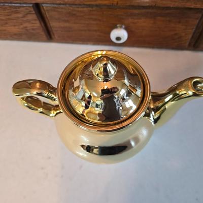 Tea time! Lillian Vernon tea pot - with other tea pots and a set of mid-century demitasse cup and saucer set with a floral pattern.