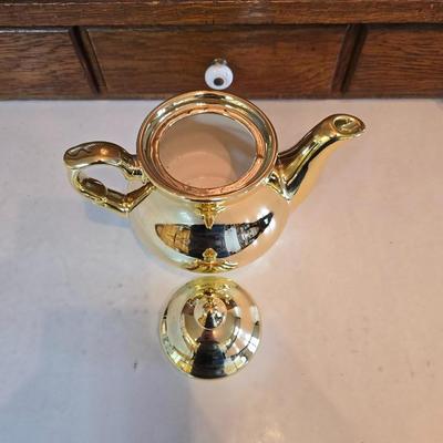 Tea time! Lillian Vernon tea pot - with other tea pots and a set of mid-century demitasse cup and saucer set with a floral pattern.