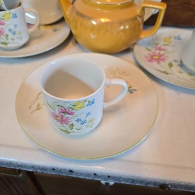 Tea time! Lillian Vernon tea pot - with other tea pots and a set of mid-century demitasse cup and saucer set with a floral pattern.