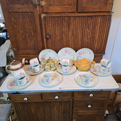 Tea time! Lillian Vernon tea pot - with other tea pots and a set of mid-century demitasse cup and saucer set with a floral pattern.