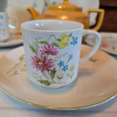Tea time! Lillian Vernon tea pot - with other tea pots and a set of mid-century demitasse cup and saucer set with a floral pattern.