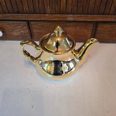 Tea time! Lillian Vernon tea pot - with other tea pots and a set of mid-century demitasse cup and saucer set with a floral pattern.