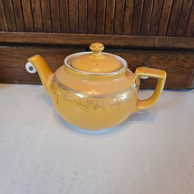 Tea time! Lillian Vernon tea pot - with other tea pots and a set of mid-century demitasse cup and saucer set with a floral pattern.
