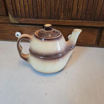 Tea time! Lillian Vernon tea pot - with other tea pots and a set of mid-century demitasse cup and saucer set with a floral pattern.