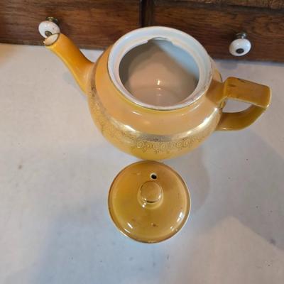 Tea time! Lillian Vernon tea pot - with other tea pots and a set of mid-century demitasse cup and saucer set with a floral pattern.