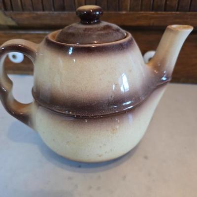 Tea time! Lillian Vernon tea pot - with other tea pots and a set of mid-century demitasse cup and saucer set with a floral pattern.