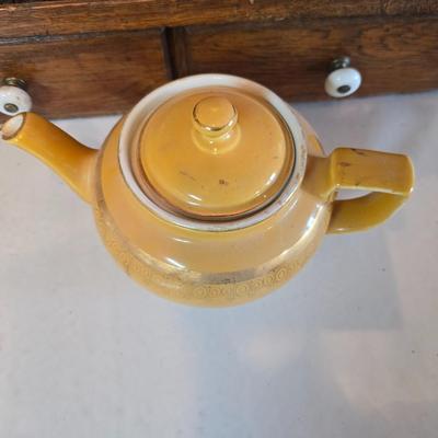 Tea time! Lillian Vernon tea pot - with other tea pots and a set of mid-century demitasse cup and saucer set with a floral pattern.