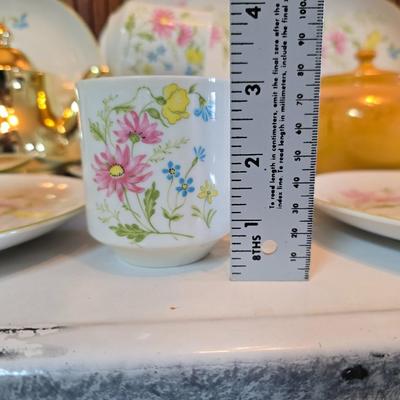Tea time! Lillian Vernon tea pot - with other tea pots and a set of mid-century demitasse cup and saucer set with a floral pattern.