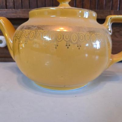 Tea time! Lillian Vernon tea pot - with other tea pots and a set of mid-century demitasse cup and saucer set with a floral pattern.