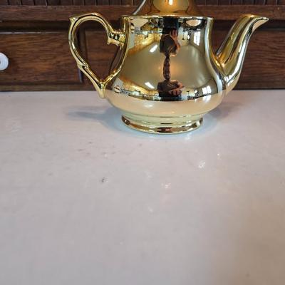 Tea time! Lillian Vernon tea pot - with other tea pots and a set of mid-century demitasse cup and saucer set with a floral pattern.