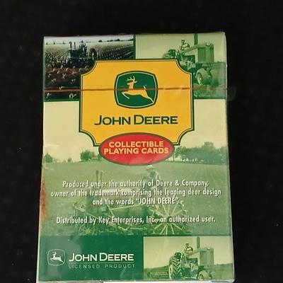 John Deere - Framed signed & numbered tractor scene by Colette McLaughlin 6/460 with John Deere cap and a deck of John deere playing...