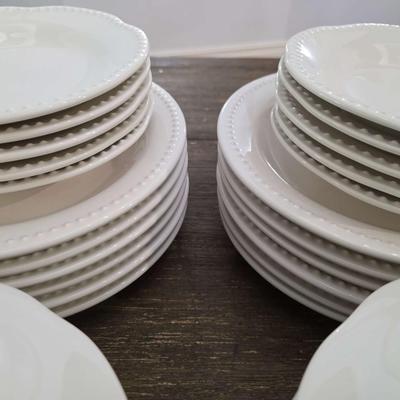 Sale Photo Thumbnail #147: This is a lot including dinner plates and bowls by Pottery Barn, "Emma" pattern with a beaded edge. A few do show signs of wear (light gray lines), but only a few of them. The salad plates and dessert bowls are by Ballard Designs. They are the same white 