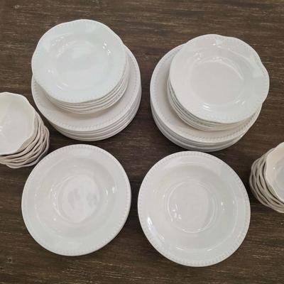 Sale Photo Thumbnail #140: This is a lot including dinner plates and bowls by Pottery Barn, "Emma" pattern with a beaded edge. A few do show signs of wear (light gray lines), but only a few of them. The salad plates and dessert bowls are by Ballard Designs. They are the same white 