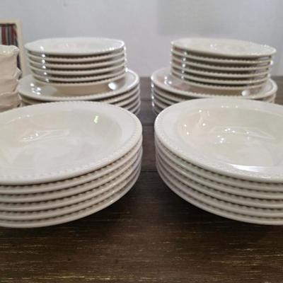 Sale Photo Thumbnail #142: This is a lot including dinner plates and bowls by Pottery Barn, "Emma" pattern with a beaded edge. A few do show signs of wear (light gray lines), but only a few of them. The salad plates and dessert bowls are by Ballard Designs. They are the same white 