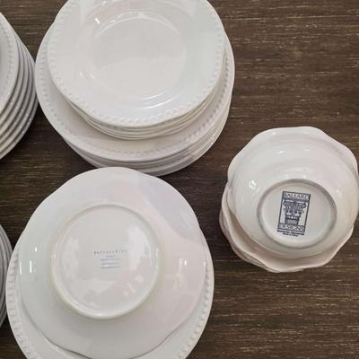 Sale Photo Thumbnail #146: This is a lot including dinner plates and bowls by Pottery Barn, "Emma" pattern with a beaded edge. A few do show signs of wear (light gray lines), but only a few of them. The salad plates and dessert bowls are by Ballard Designs. They are the same white 