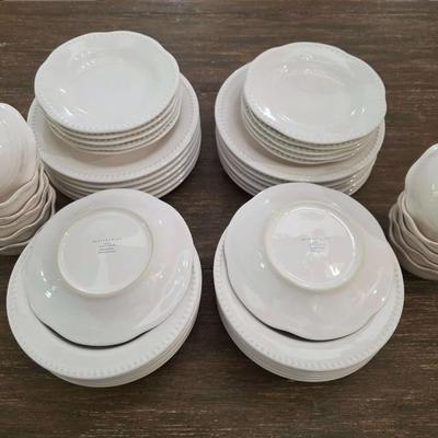 Sale Photo Thumbnail #144: This is a lot including dinner plates and bowls by Pottery Barn, "Emma" pattern with a beaded edge. A few do show signs of wear (light gray lines), but only a few of them. The salad plates and dessert bowls are by Ballard Designs. They are the same white 