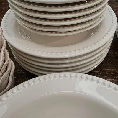 Sale Photo Thumbnail #143: This is a lot including dinner plates and bowls by Pottery Barn, "Emma" pattern with a beaded edge. A few do show signs of wear (light gray lines), but only a few of them. The salad plates and dessert bowls are by Ballard Designs. They are the same white 