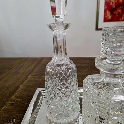 Sale Photo Thumbnail #158: This is a lot including 3 crystal decanters with a hammered silver tray. One decanter is Waterford, one is Gorham and the other is unmarked, No flaws noticed. This is a lot meaning you must pay for and take the entire lot.