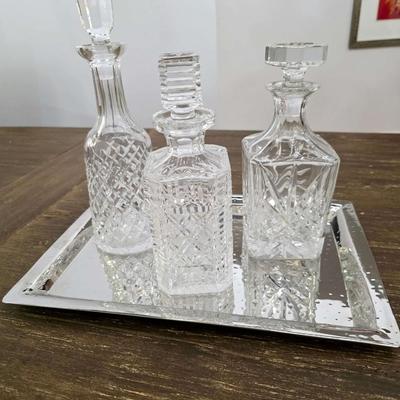 Sale Photo Thumbnail #149: This is a lot including 3 crystal decanters with a hammered silver tray. One decanter is Waterford, one is Gorham and the other is unmarked, No flaws noticed. This is a lot meaning you must pay for and take the entire lot.