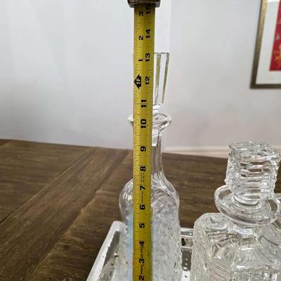 Sale Photo Thumbnail #160: This is a lot including 3 crystal decanters with a hammered silver tray. One decanter is Waterford, one is Gorham and the other is unmarked, No flaws noticed. This is a lot meaning you must pay for and take the entire lot.