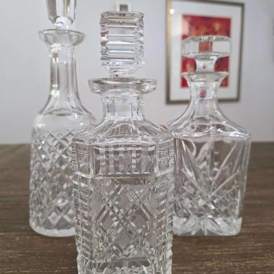 Sale Photo Thumbnail #150: This is a lot including 3 crystal decanters with a hammered silver tray. One decanter is Waterford, one is Gorham and the other is unmarked, No flaws noticed. This is a lot meaning you must pay for and take the entire lot.