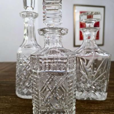 Sale Photo Thumbnail #151: This is a lot including 3 crystal decanters with a hammered silver tray. One decanter is Waterford, one is Gorham and the other is unmarked, No flaws noticed. This is a lot meaning you must pay for and take the entire lot.