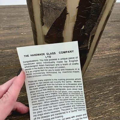 Sale Photo Thumbnail #177: Stunning handmade blown glass art vase in metallics (silver leaf) and browns by Adam Aaronson from his studio in London. This is a timeless glass art piece. It measures 12" tall and is rather heavy. The wall art you may see in the background is NOT includ